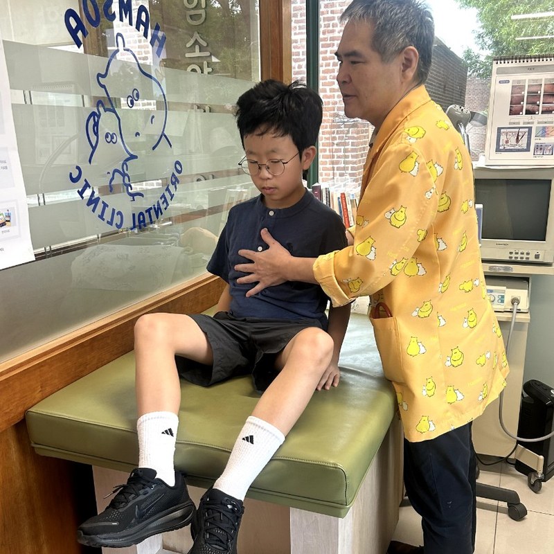 The doctor checking in with a young patient at the clinic window, Hamsoa NY